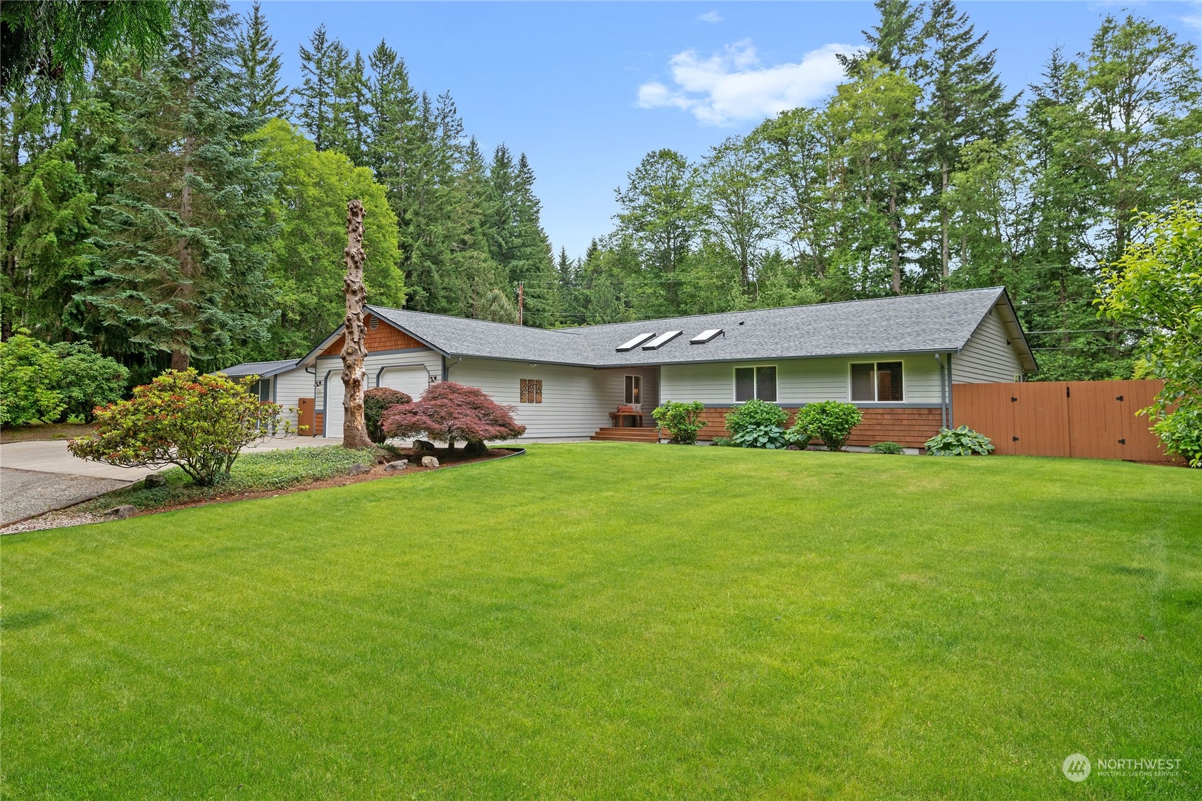 3860 Northeast Iverson Road Poulsbo, WA 98370 - Photo 2 of 40 a front view of a house with a garden