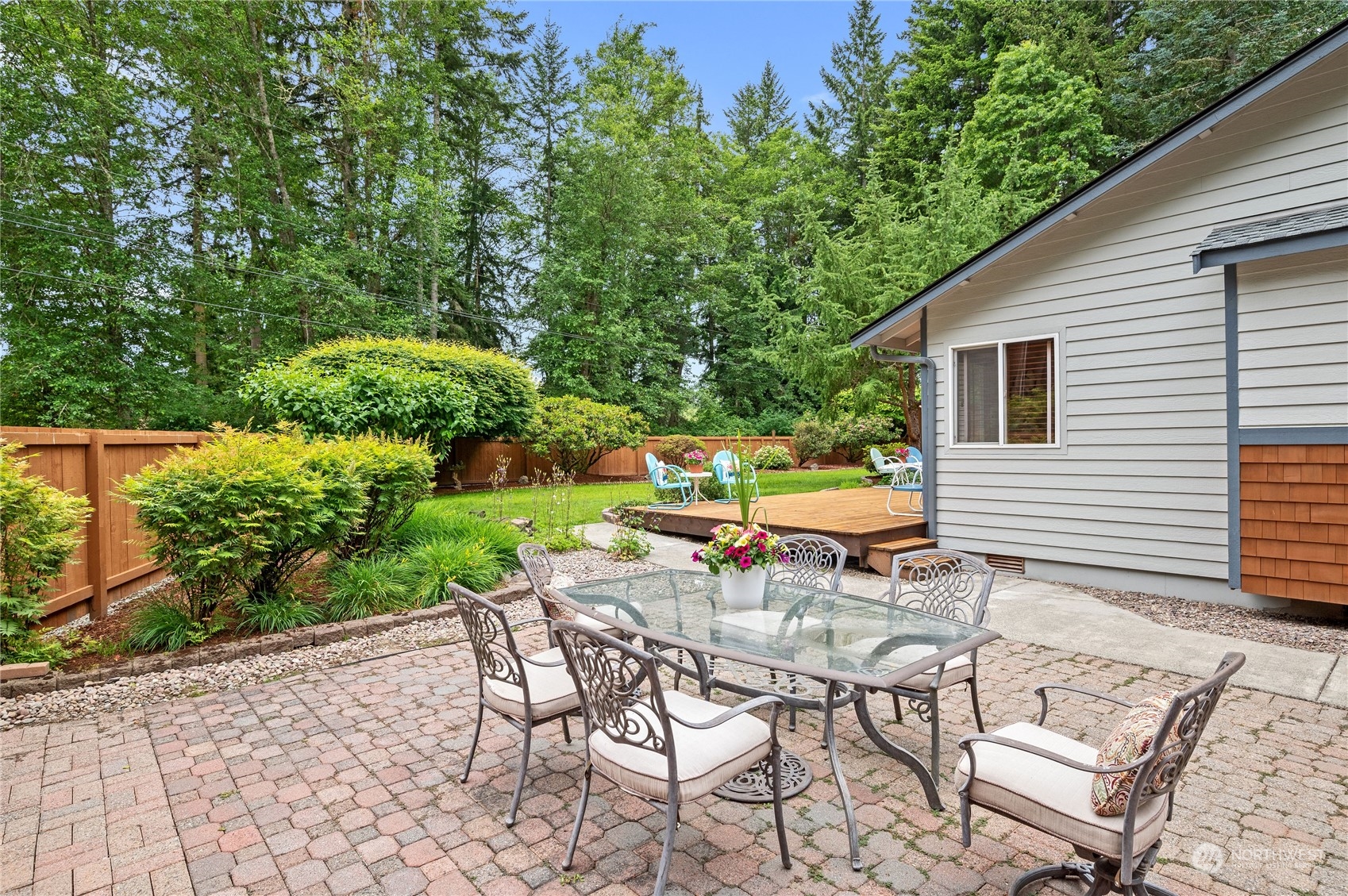 3860 Northeast Iverson Road Poulsbo, WA 98370 - Photo 29 of 40 a patio with glass top table and chairs
