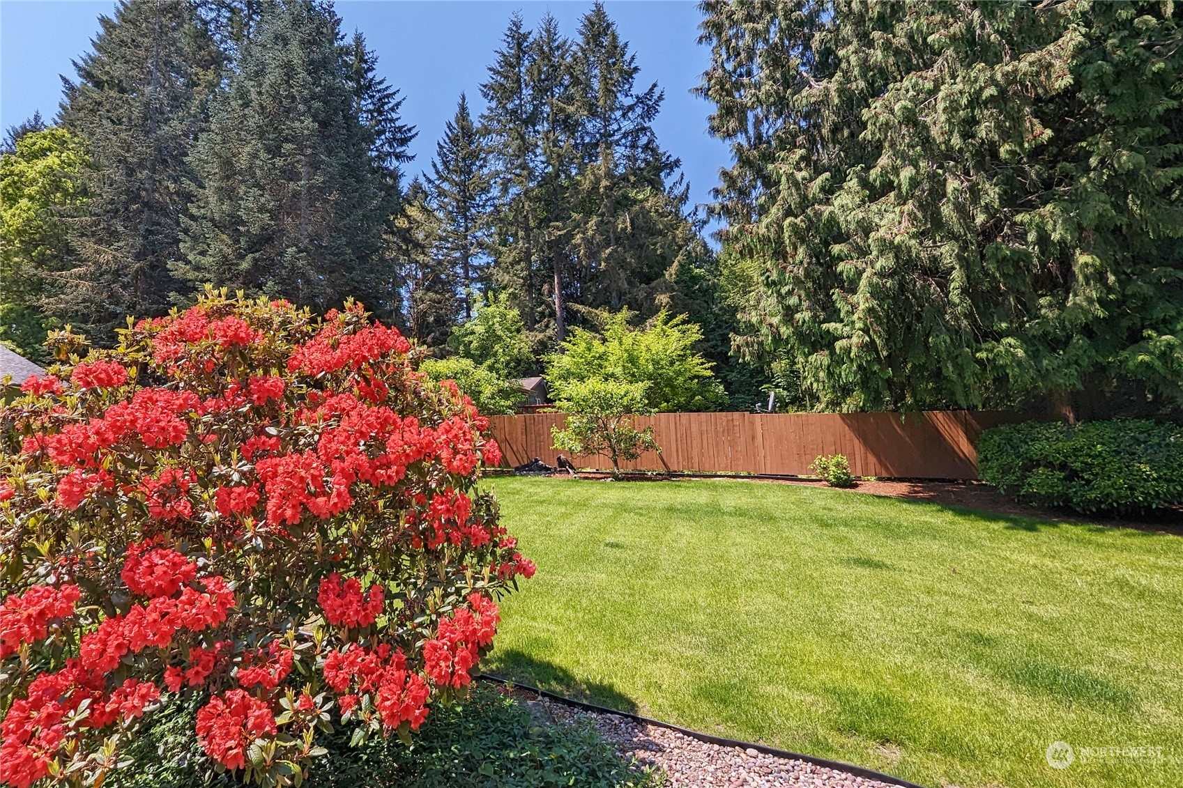 3860 Northeast Iverson Road Poulsbo, WA 98370 - Photo 33 of 40 a view of a house with a yard and garden