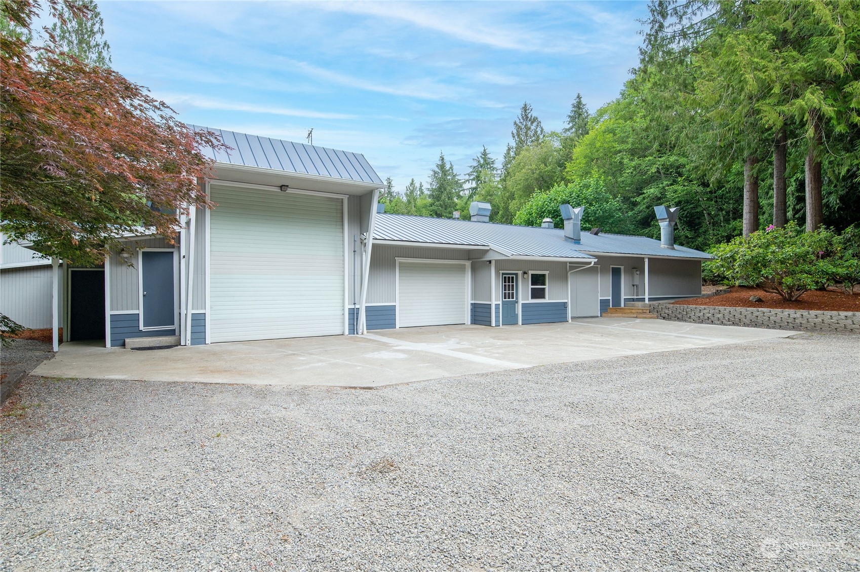 3860 Northeast Iverson Road Poulsbo, WA 98370 - Photo 35 of 40 front view of a house with a large window and potted plants