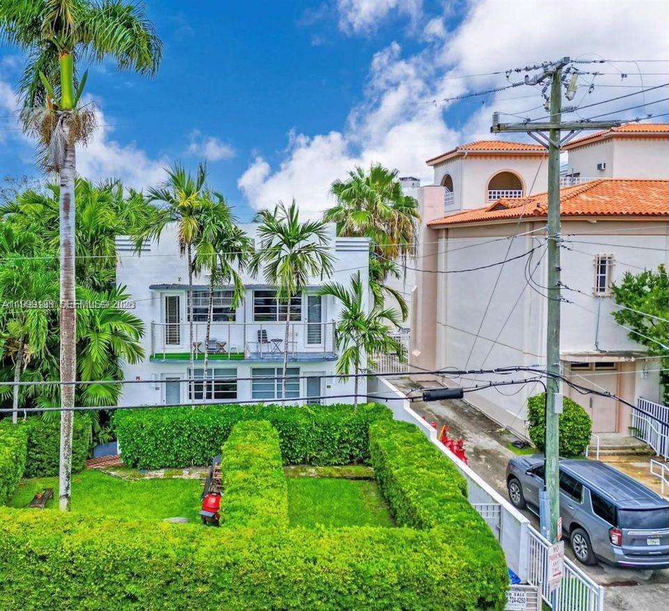 3915 Meridian Avenue, Unit 101 Miami Beach, FL 33140 - Photo 13 of 19 a front view of a house with a yard and potted plants