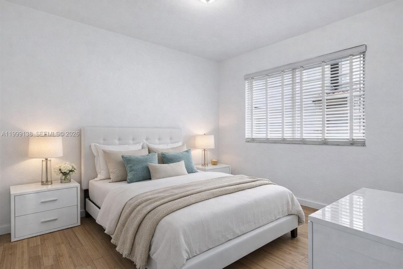 3915 Meridian Avenue, Unit 101 Miami Beach, FL 33140 - Photo 2 of 19 a bedroom with a bed and a window