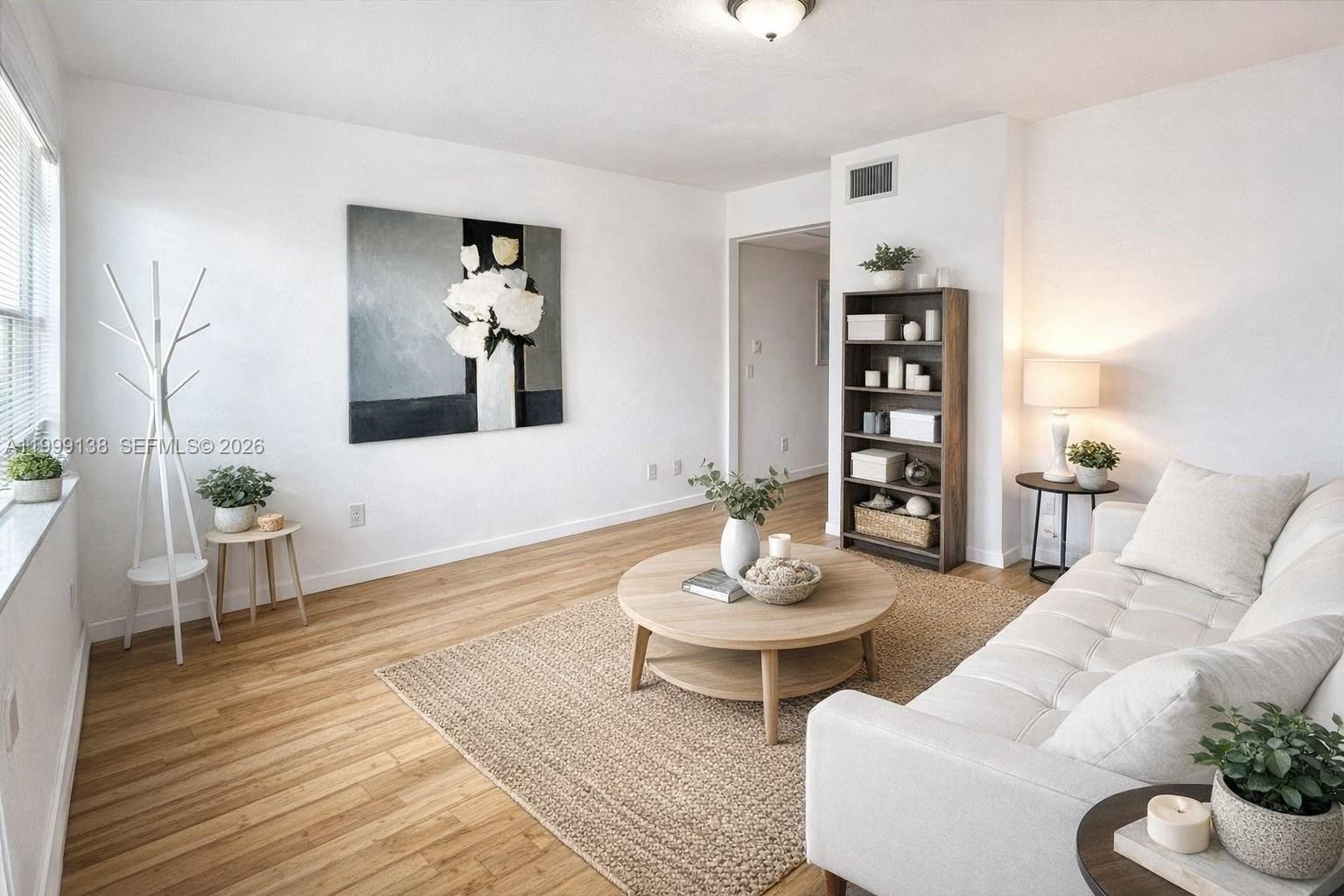 3915 Meridian Avenue, Unit 101 Miami Beach, FL 33140 - Photo 4 of 19 a living room with furniture and wooden floor