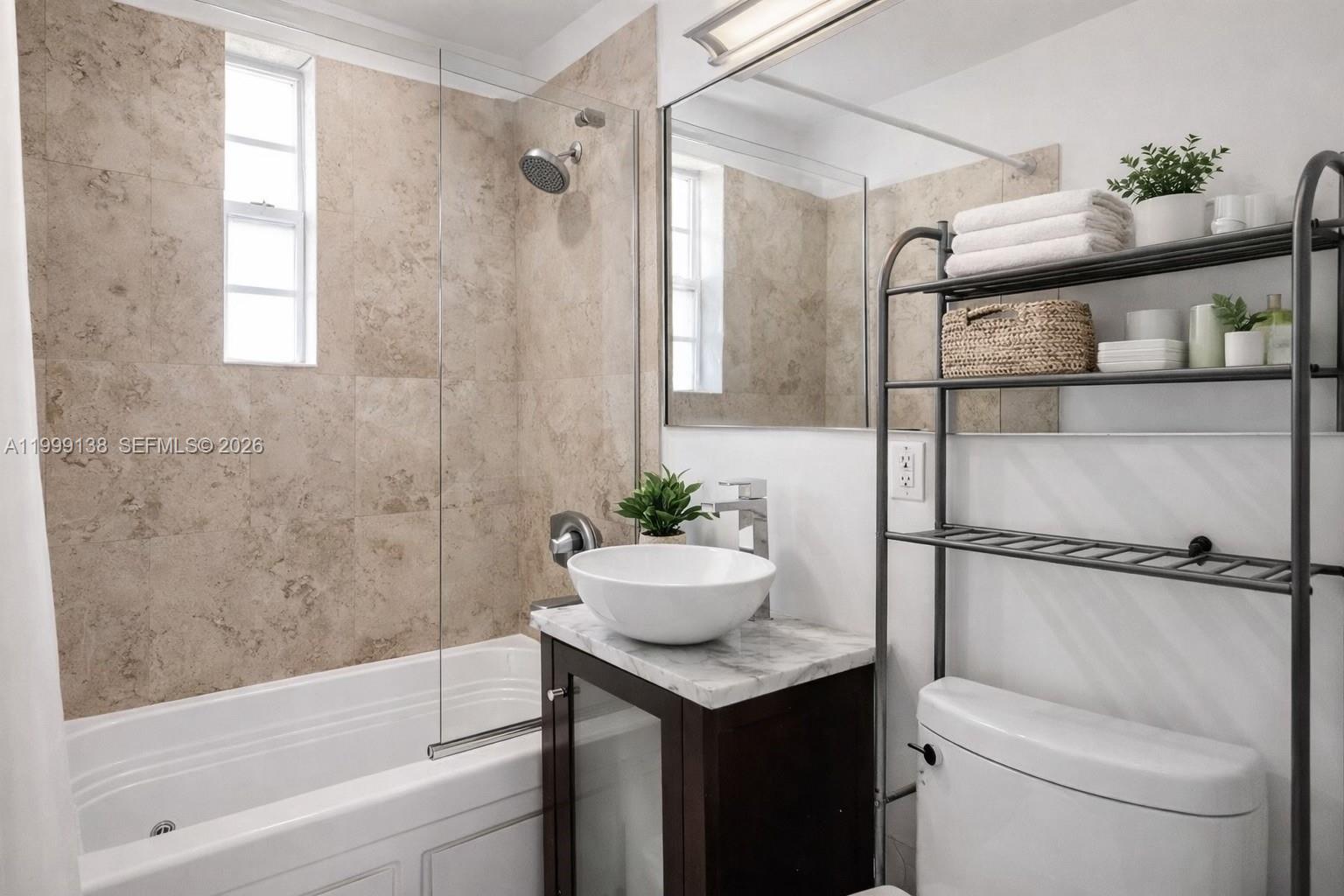 3915 Meridian Avenue, Unit 101 Miami Beach, FL 33140 - Photo 8 of 19 a bathroom with a sink toilet and shower