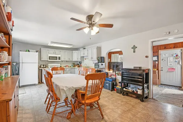 a dining room with furniture and wooden floor