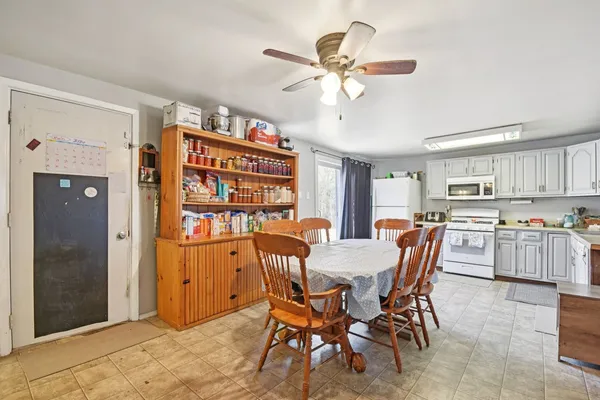 a view of a dining room with furniture and a chandelier