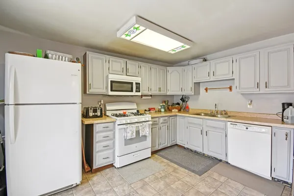 a kitchen with cabinets stainless steel appliances and a counter space