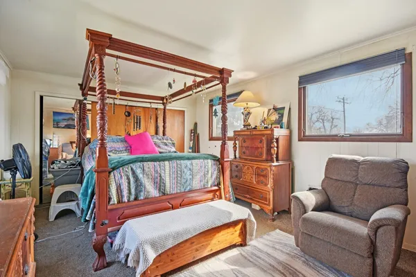 a bedroom with a bed and a couch
