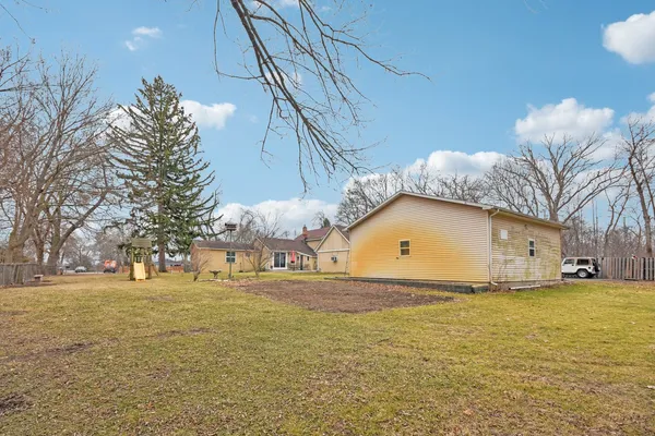a view of a house with a yard and garage