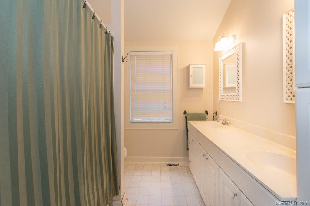 708 Ellsworth Road Charlotte, NC 28211 - Photo 14 of 24 a bathroom with a double vanity sink a mirror and a bathtub