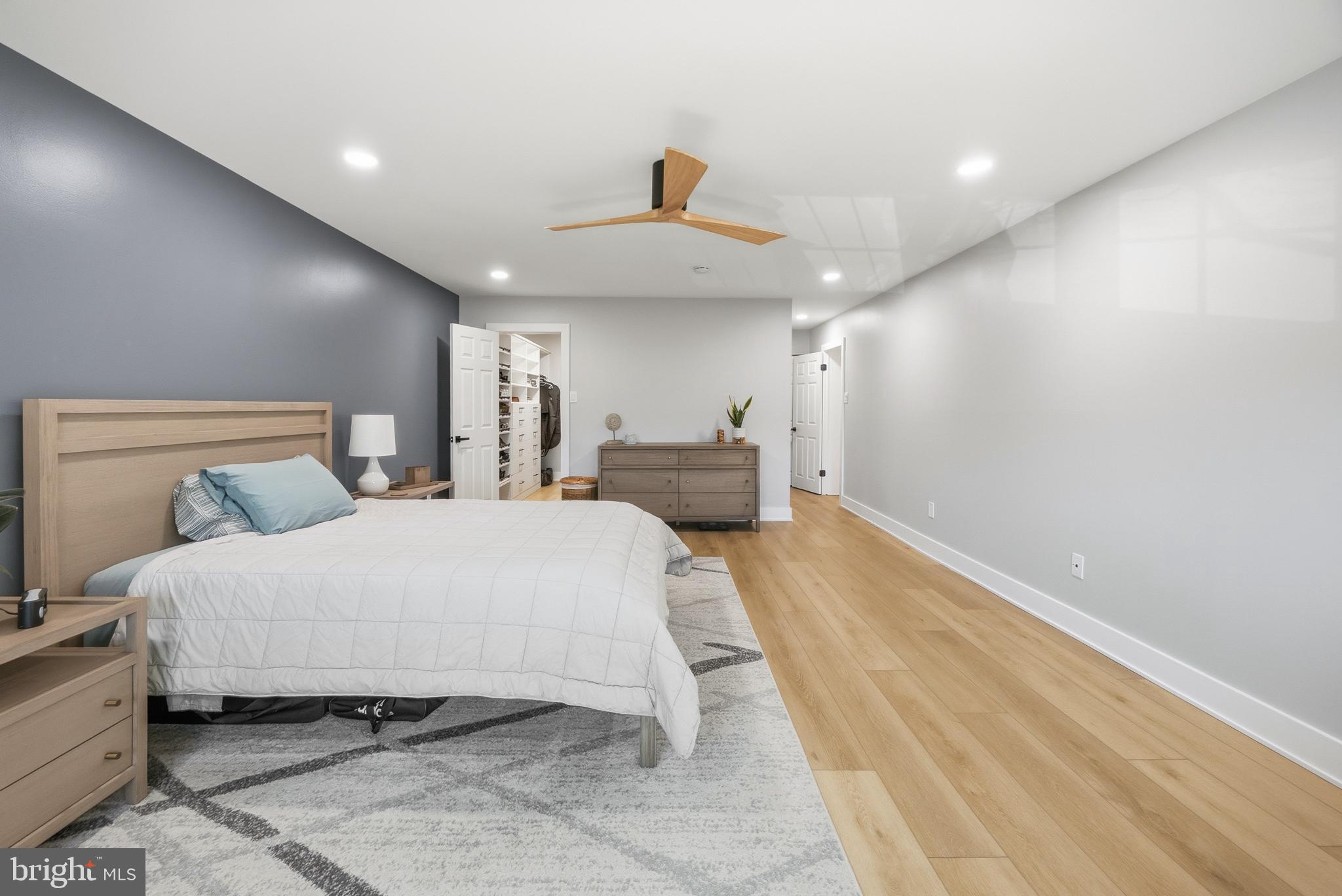 15 Haddonfield Cmns, Unit 15 Haddonfield, NJ 08033 - Photo 16 of 48 a spacious bedroom with a bed and a chandelier