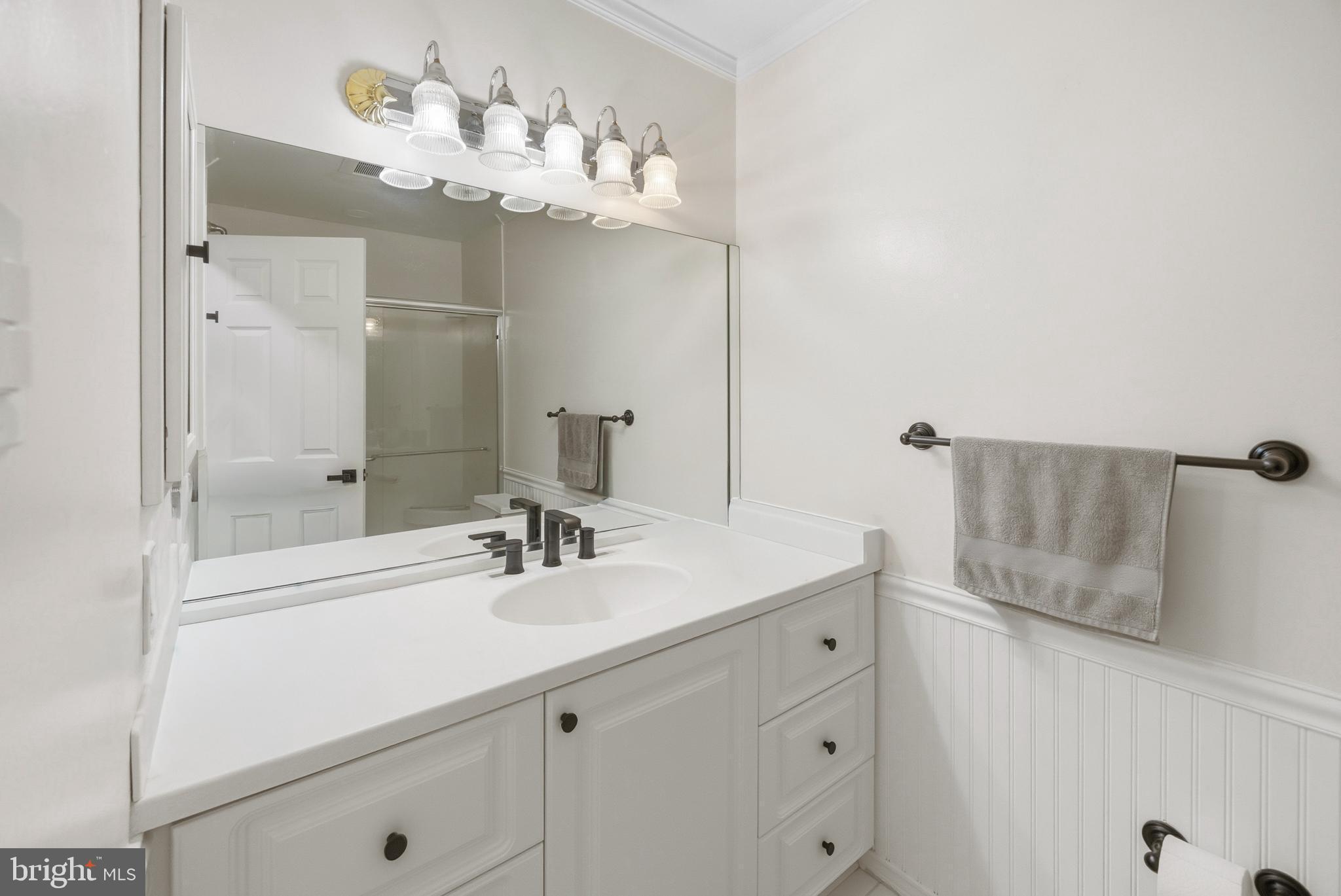 15 Haddonfield Cmns, Unit 15 Haddonfield, NJ 08033 - Photo 19 of 48 a bathroom with a sink a mirror and a shower