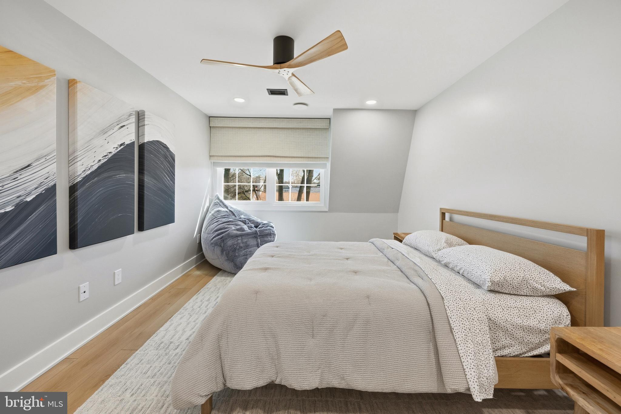 15 Haddonfield Cmns, Unit 15 Haddonfield, NJ 08033 - Photo 20 of 48 a bedroom with a large bed and a chandelier