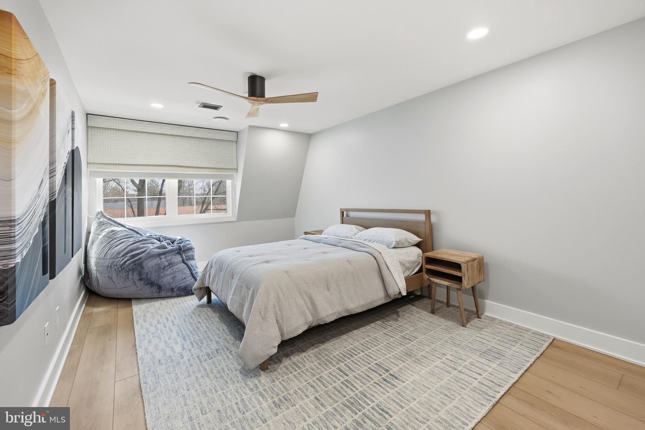 15 Haddonfield Cmns, Unit 15 Haddonfield, NJ 08033 - Photo 21 of 48 a bedroom with a large bed and a chandelier