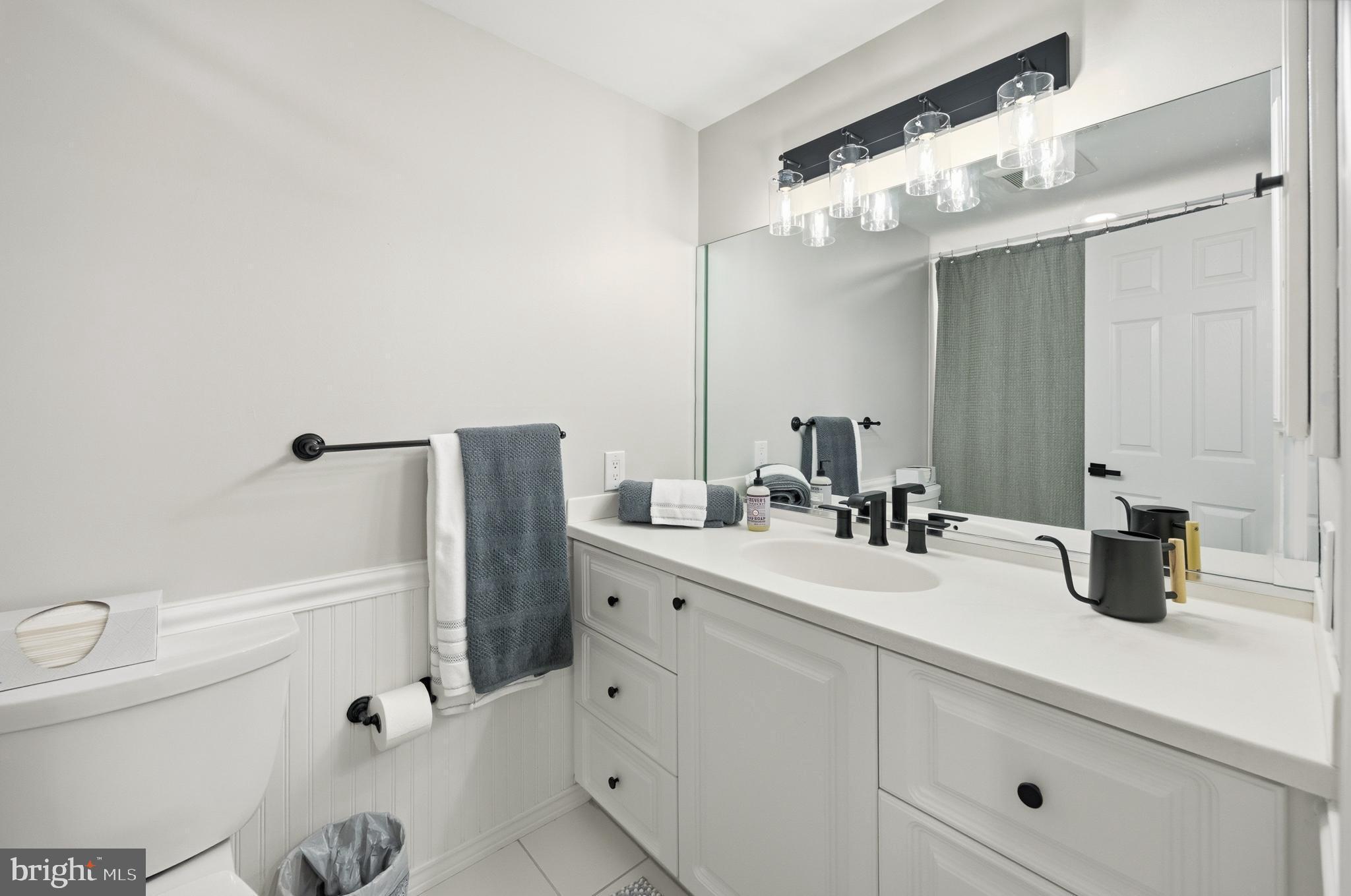 15 Haddonfield Cmns, Unit 15 Haddonfield, NJ 08033 - Photo 26 of 48 a bathroom with a double vanity sink toilet and mirror
