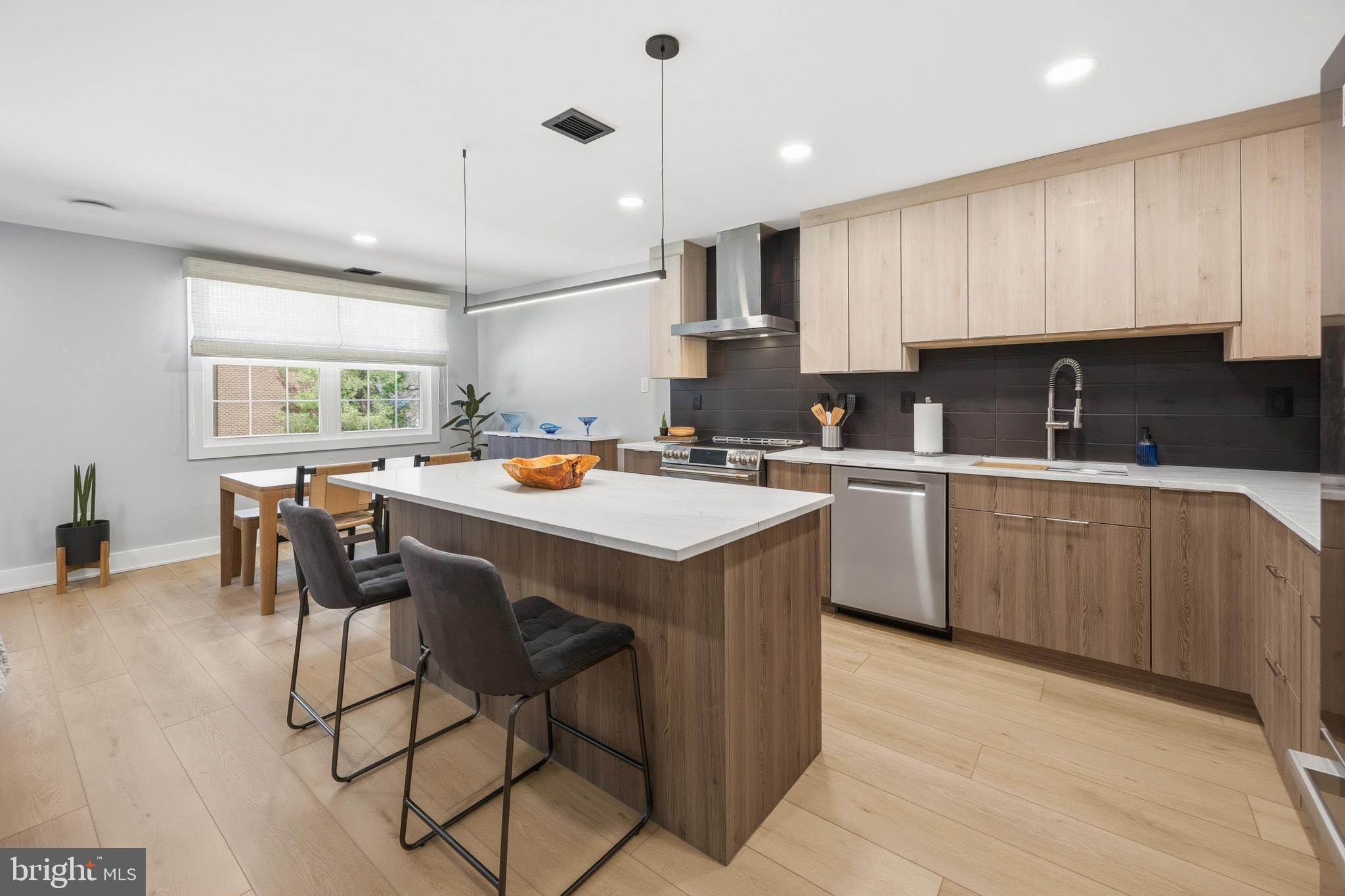 15 Haddonfield Cmns, Unit 15 Haddonfield, NJ 08033 - Photo 3 of 48 a kitchen with a sink a cabinets and chairs