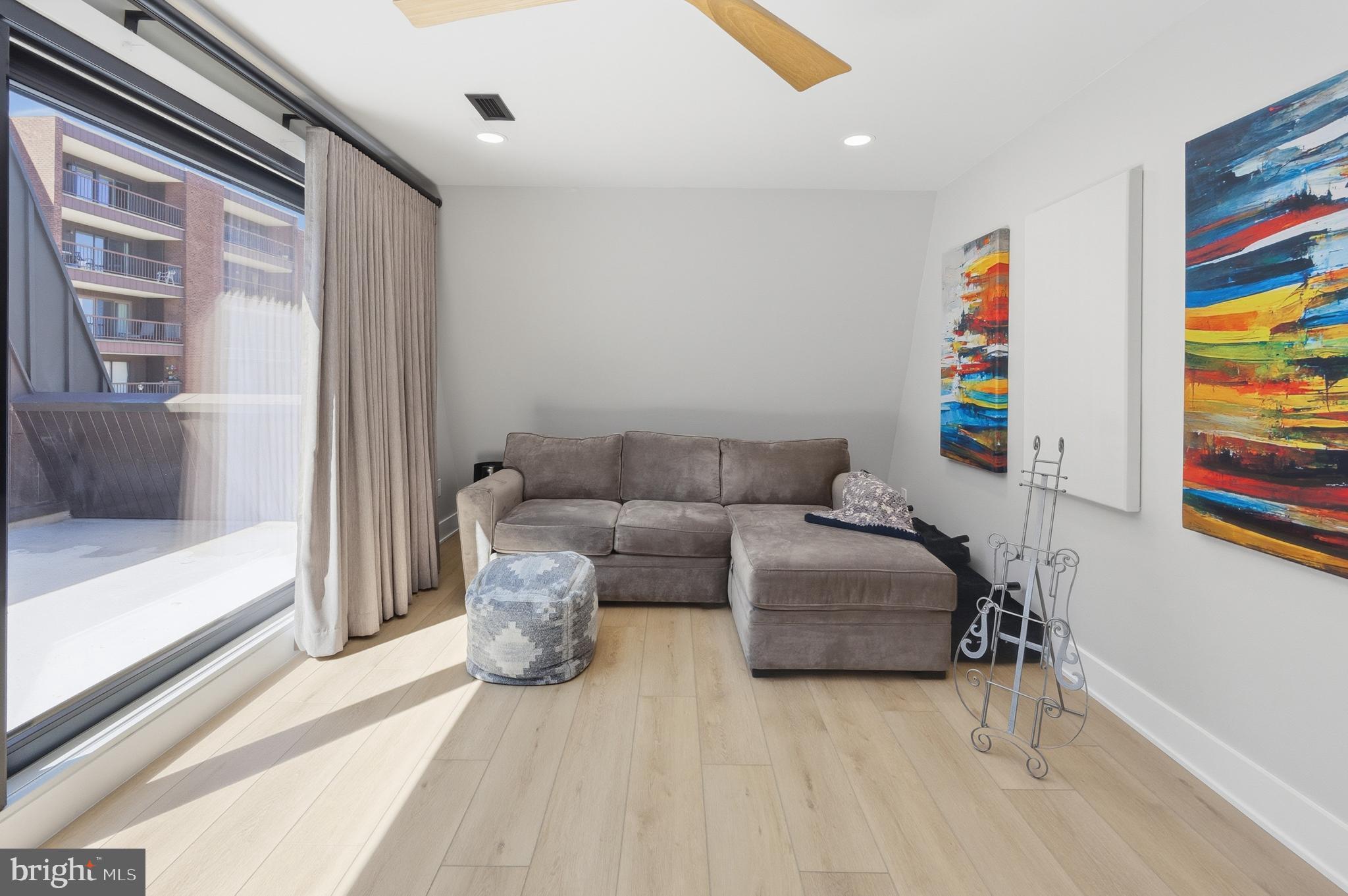 15 Haddonfield Cmns, Unit 15 Haddonfield, NJ 08033 - Photo 33 of 48 a living room with furniture and a floor to ceiling window