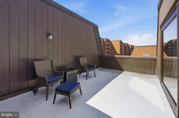 a balcony with table and chairs