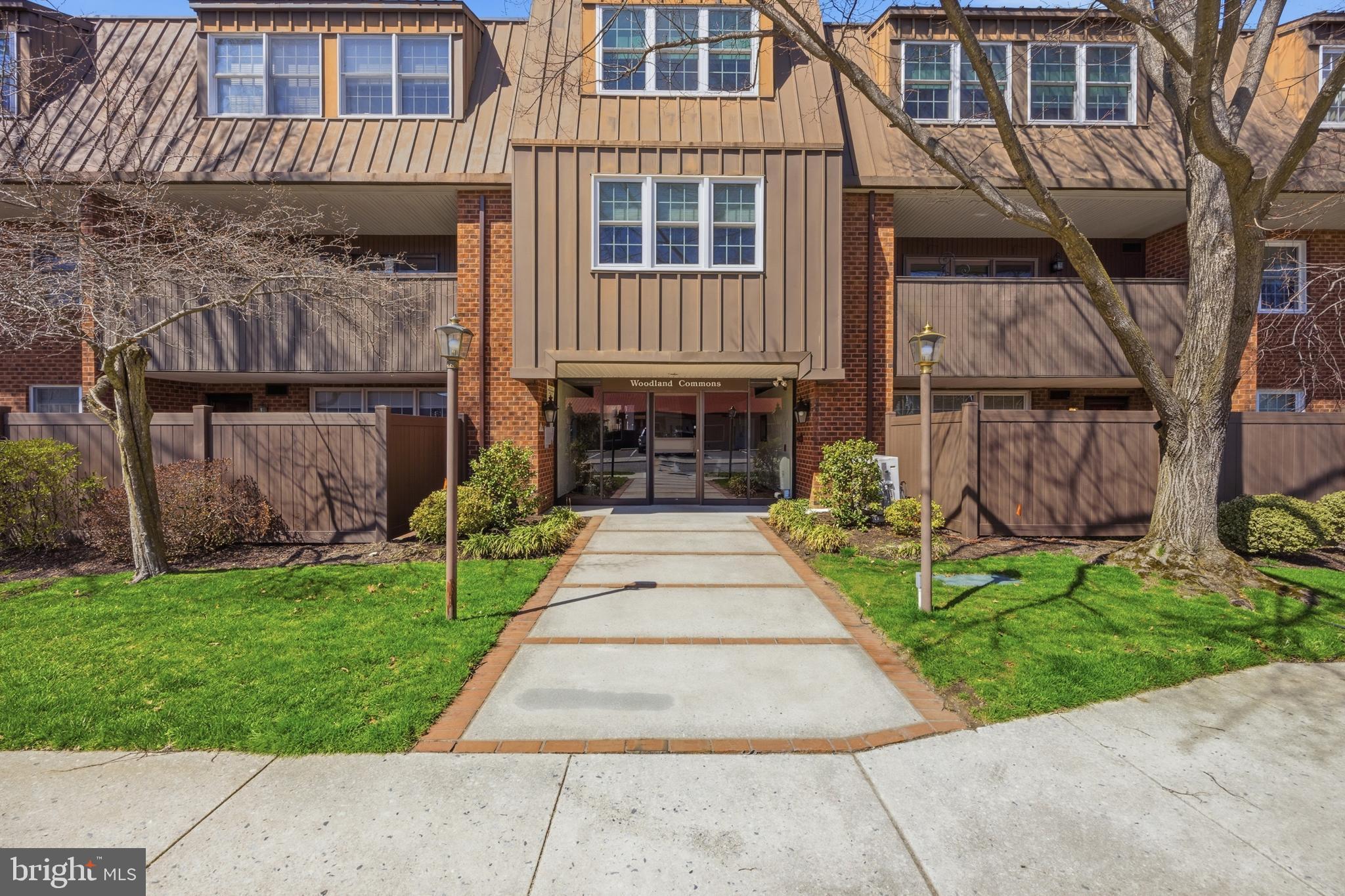 15 Haddonfield Cmns, Unit 15 Haddonfield, NJ 08033 - Photo 48 of 48 a front view of a house with a garden