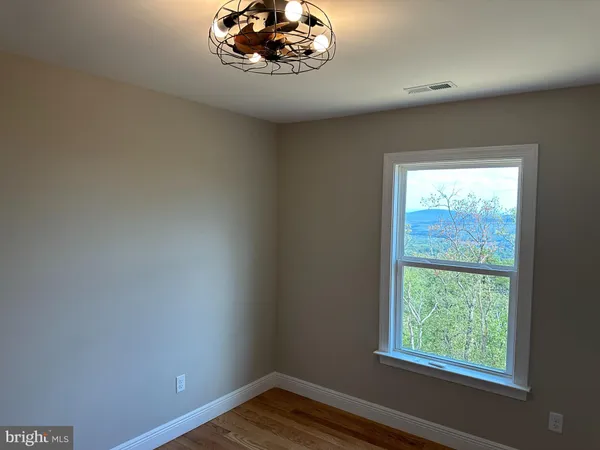 a view of a room with a large window and a fireplace