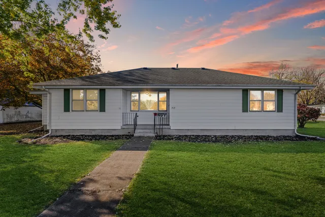 a front view of a house with a yard