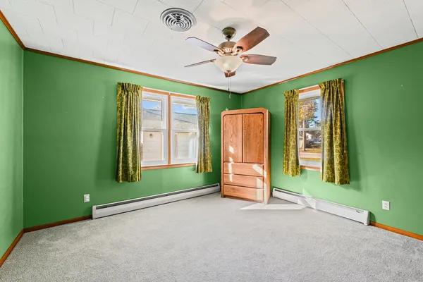 a view of a livingroom with a ceiling fan and window