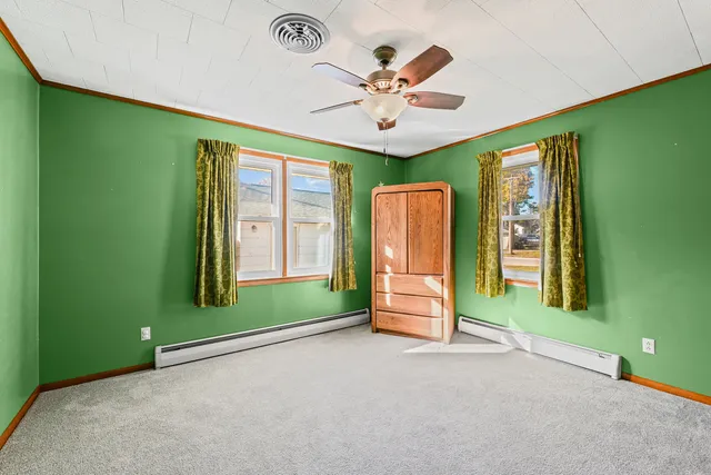 a view of a livingroom with a ceiling fan and window