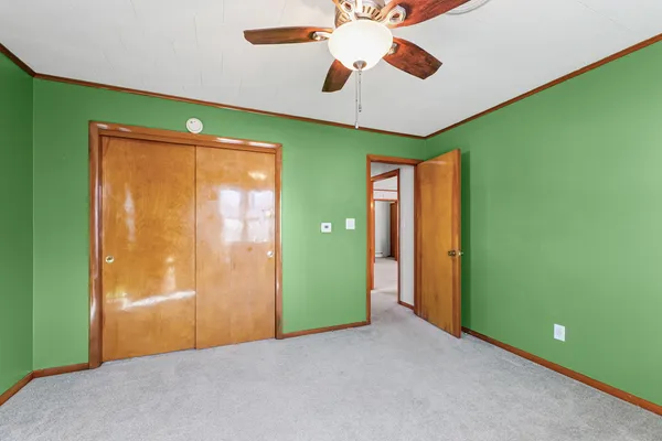 a view of a room with a window and a ceiling fan