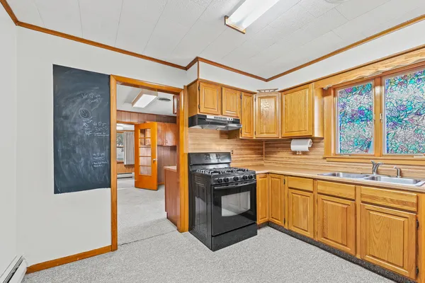 a kitchen with stainless steel appliances granite countertop a stove a sink and a refrigerator