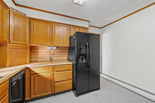 a kitchen with stainless steel appliances a refrigerator and cabinets
