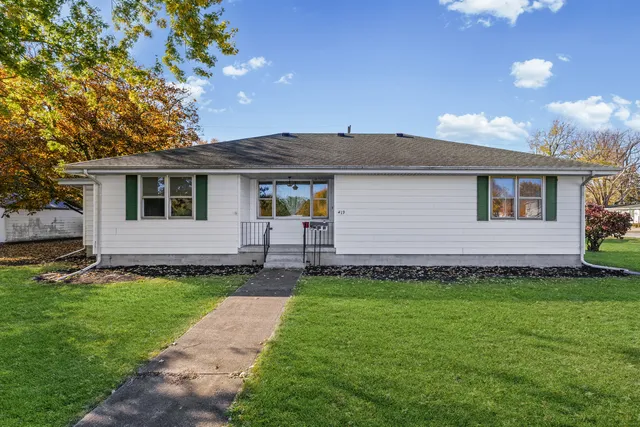 a front view of a house with a garden