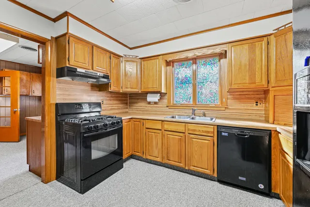 a kitchen with stainless steel appliances granite countertop a stove and a refrigerator