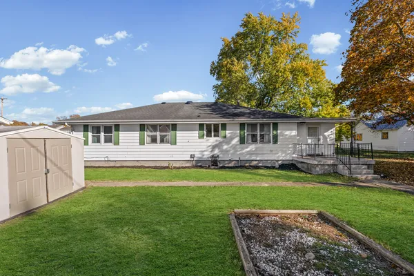 a front view of a house with a yard porch and outdoor seating