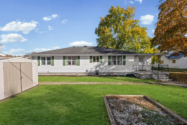 a front view of a house with a yard porch and outdoor seating