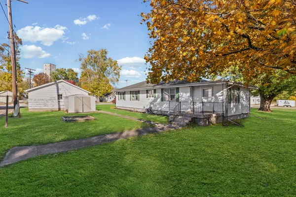a view of a house with a yard and sitting area