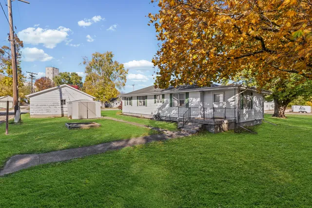 a view of a house with a yard and sitting area