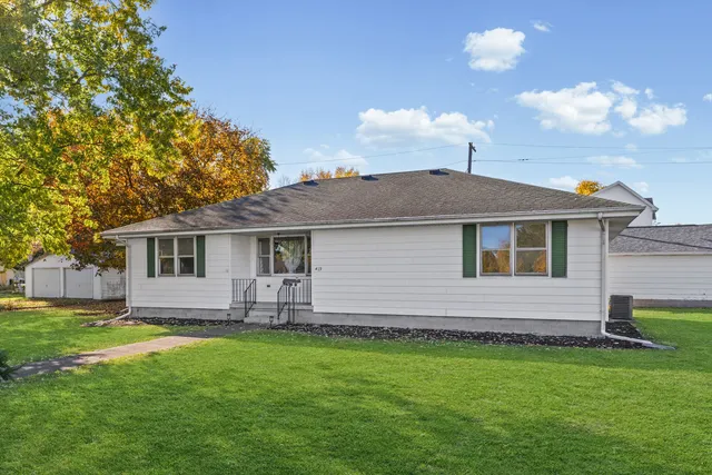a front view of house with yard and green space