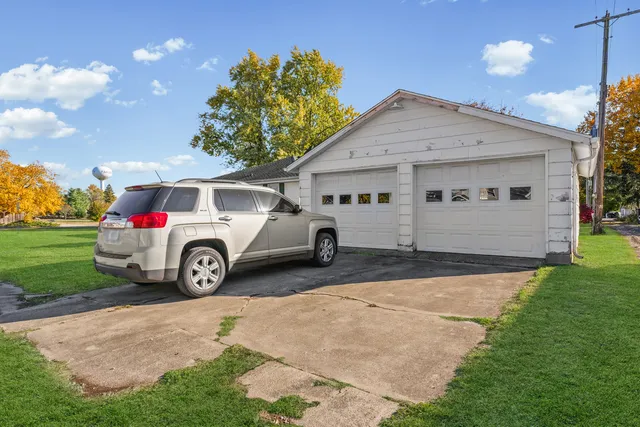 a view of a house with a yard and garage