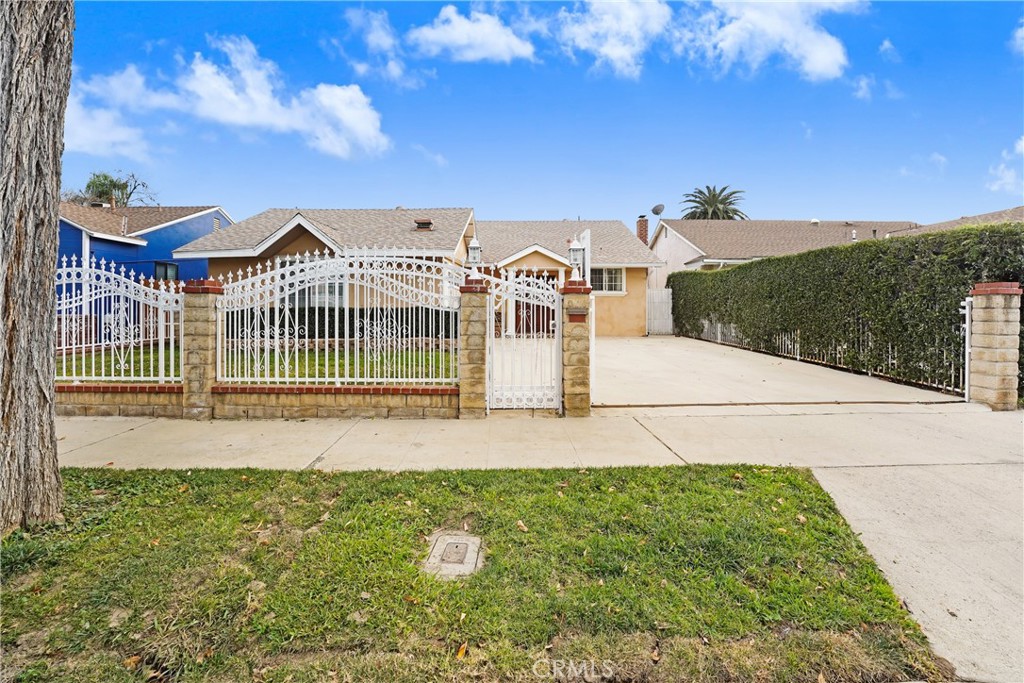 a view of a house with a yard and potted plants