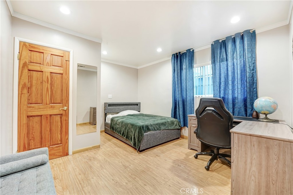 19530 Enadia Way Reseda, CA 91335 - Photo 11 of 16 a bedroom with a bed and furniture