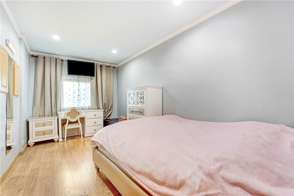 19530 Enadia Way Reseda, CA 91335 - Photo 12 of 16 a spacious bedroom with a bed and wooden floor