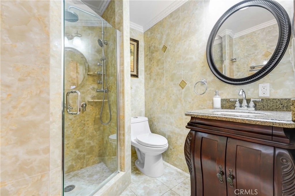 19530 Enadia Way Reseda, CA 91335 - Photo 13 of 16 a bathroom with a sink a toilet and a mirror