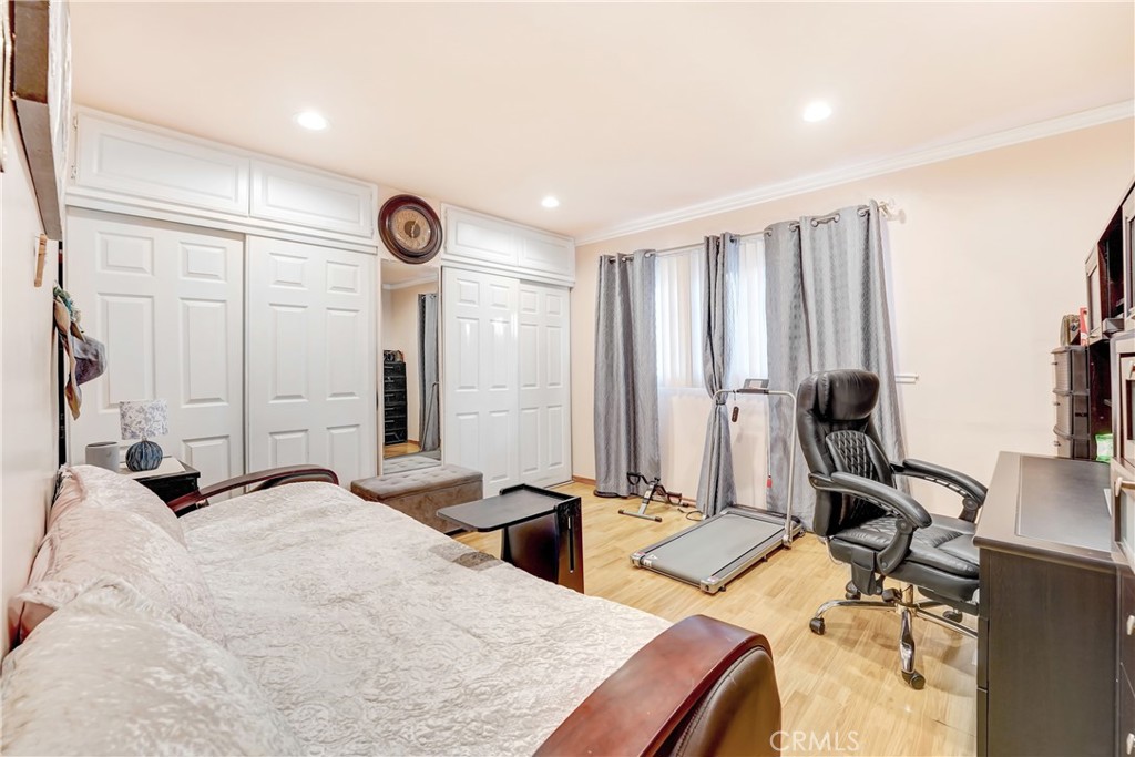 19530 Enadia Way Reseda, CA 91335 - Photo 14 of 16 a bedroom with a bed and a large mirror