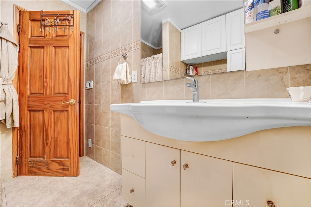 19530 Enadia Way Reseda, CA 91335 - Photo 15 of 16 a bathroom with a sink and a mirror