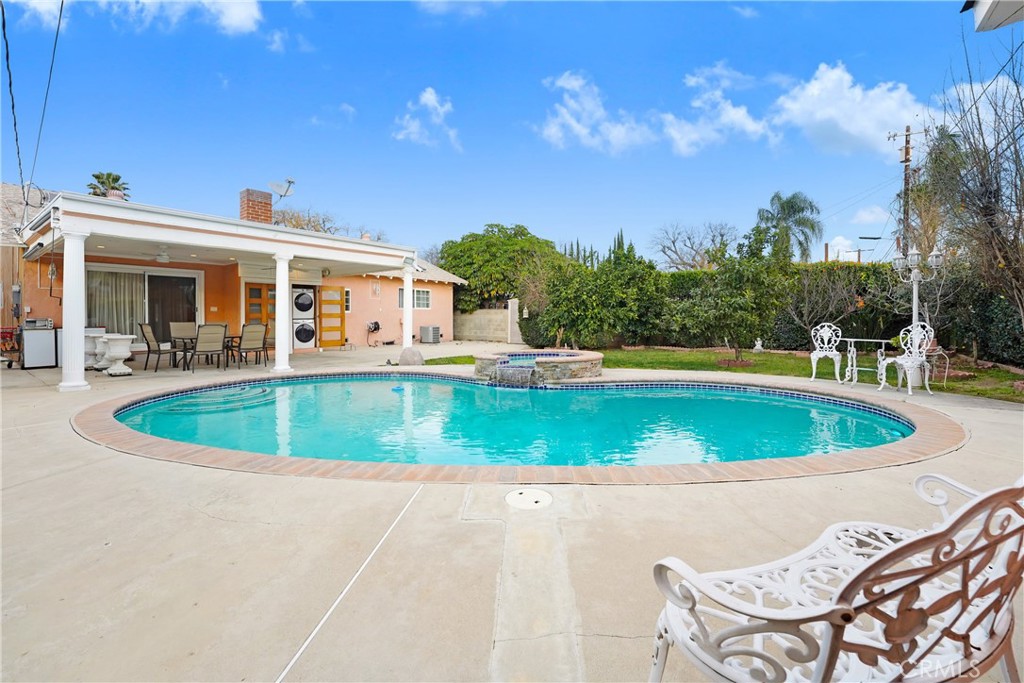 19530 Enadia Way Reseda, CA 91335 - Photo 16 of 16 a view of a swimming pool with a patio