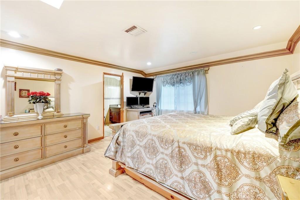 19530 Enadia Way Reseda, CA 91335 - Photo 9 of 16 a spacious bedroom with a large bed and a dresser