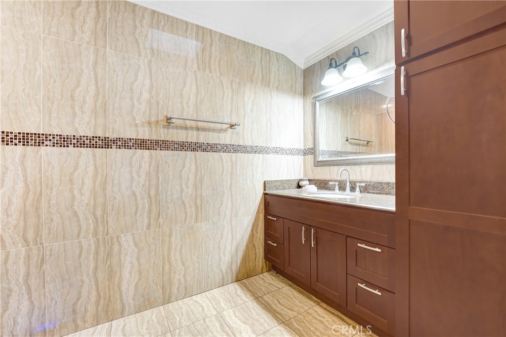 19530 Enadia Way Reseda, CA 91335 - Photo 10 of 16 a bathroom with a sink a mirror and a shower curtain