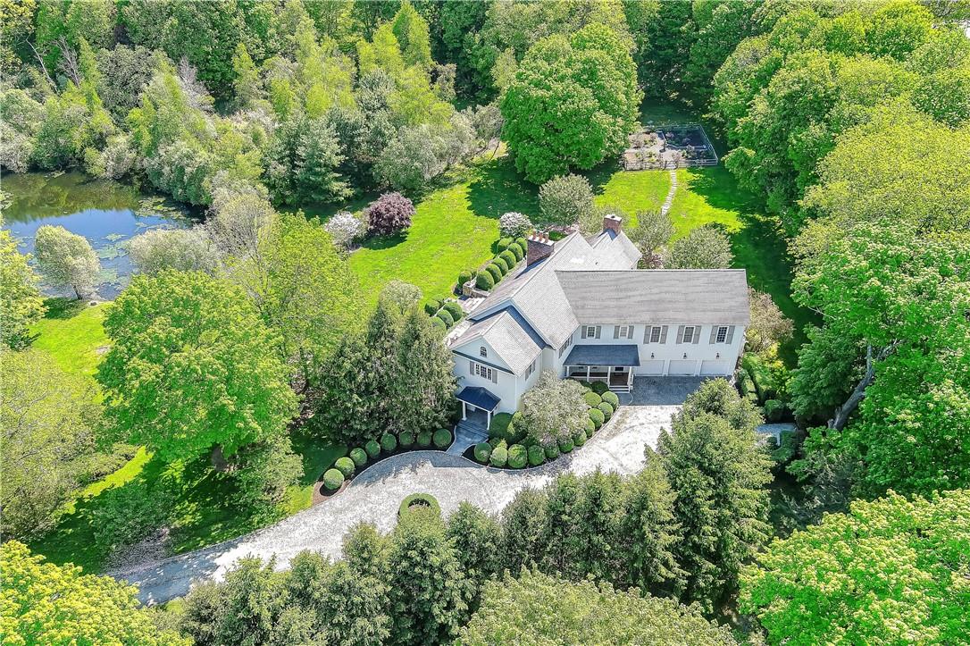 an aerial view of a house with a yard and lake view