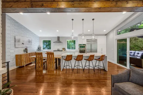 a large kitchen with a table and chairs