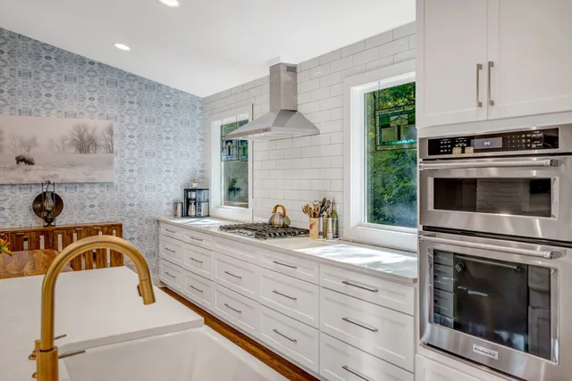 a kitchen with granite countertop a sink and a stove top oven